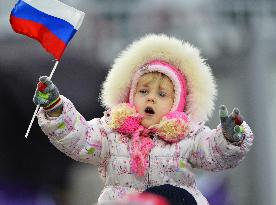 Little girl waves Russian flag during men's moguls final