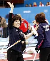 Tomabechi of Japan curling team smiles after beating Russia