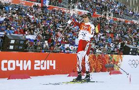 Japan's A. Watabe pumps fist as he finishes 2nd in Nordic combined