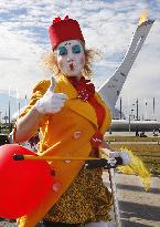 Female street performer rides skateboard in Olympic Park in Sochi