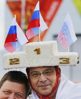 Olympics visitor shows off podium-shaped cap in Sochi