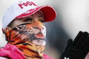 Tiger mask woman cheers for alpine skiers at Sochi