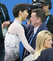 Hanyu hugs coach Orser after winning gold at Sochi