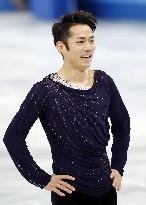Japan's figure skater Takahashi smiles after free program