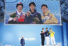 Men's figure skating medalists celebrate on podium