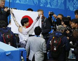 Hanyu hides behind Japanese flag after winning gold in Sochi