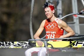 Norwegian athlete wears only bib on ski lift in warm Sochi