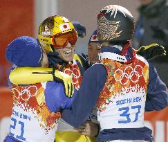 Large hill silver medalist Kasai hugs teammates