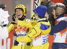Japan's Kasai rejoices with teammates after winning large hill silver