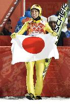 Japan's Kasai smiles after winning silver in large hill jump