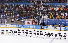 Japan players bow after loss to Germany in women's ice hockey