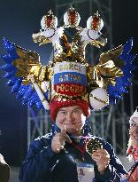 Male fan enjoys Sochi Olympics with glitzy hat on