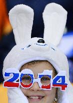 Girl enjoys Sochi Olympics with mascot hat, glasses