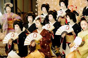 Geishas pose for photos during Kitano Odori dance rehearsal