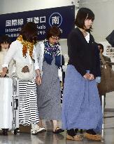 Rescued Japanese divers return home