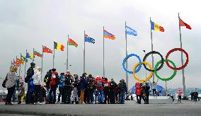 Visitors form long line in front of Olympic logo in Sochi