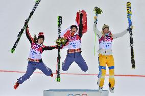 Women's freestyle skiing cross medalists celebrate on podium