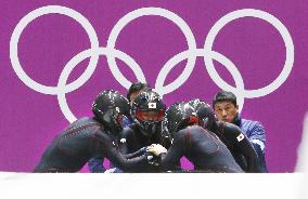 Team Japan huddles before starting men's bobsleigh race