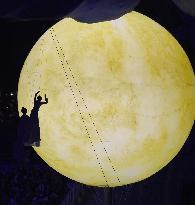 Women and moon at Closing Ceremony for Sochi Winter Olympics