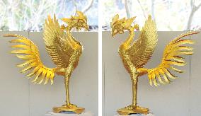 Newly gold-plated phoenix statues shown at Kyoto temple