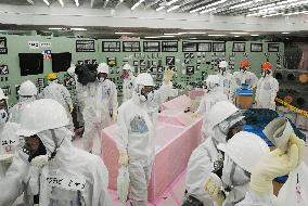 Media see reactor control room at Fukushima nuclear plant
