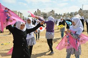 Children fly kites in Gaza for 2011 disaster victims