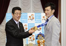 Japan's Sochi bronze winner Hiraoka shows medal to Osaka gov.