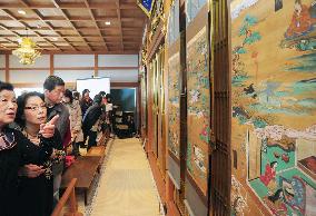People view Buddhist drawings on death at Kyoto temple