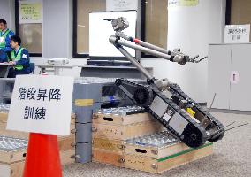 TEPCO employees practice operating remote-controlled robot