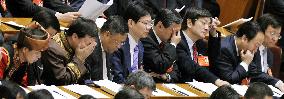 Tired participants in China's parliament session
