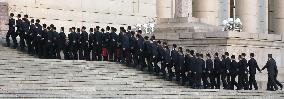Chinese security officers walk up steps