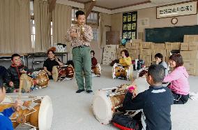 Japanese citizens practice traditional Korean drums