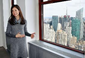 U.S. woman explains energy-saving measures at Empire State