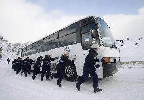 Workers push bus caught in snow at N. Korean ski resort