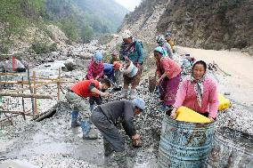 Residents engage in bridge construction in Tawang, India