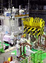 Workers decontaminate equipment at Fukushima plant