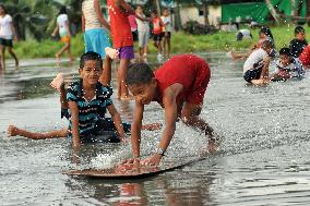 Boys play in high tide pool in Tuvalu
