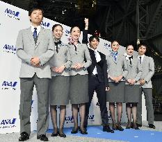 Hanyu poses with ANA flight attendants in new uniforms