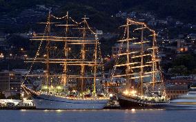 Tall ships brightly lit up at Nagasaki port fair