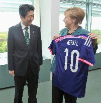 Abe presents Nadeshiko Japan jersey to Merkel