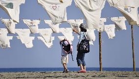1,200 T-shirts hung on beach for art exhibition