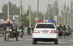 Police car patrols in Xayar in Xinjiang Uyghur region