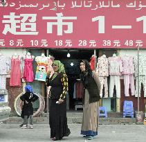 Women walk in Xayar market