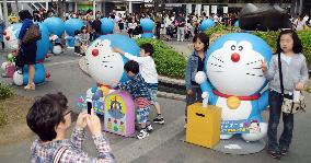 Snapshots with Doraemon figures outside Hakata station