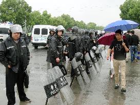 China police guard against protesters of waste disposal plan
