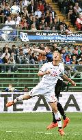Milan's Honda vies for ball against Atalanta player