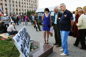 Pro-Russian people look at photos of protests against Kiev