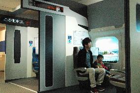 People take shinkansen simulation ride at Railway Park