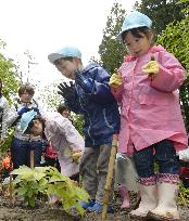 Children plant trees in 2011 quake-hit area