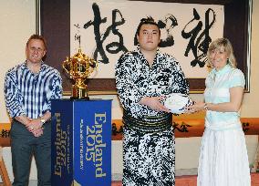 Sumo wrestler Ikioi stands next to Rugby World Cup